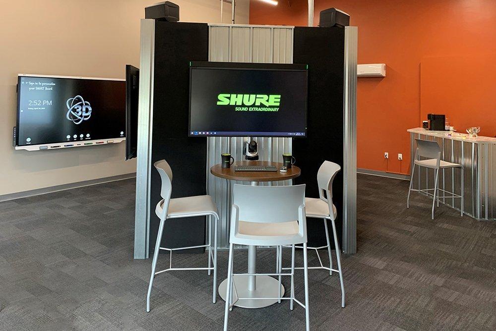 a room with a tv and a table and chairs